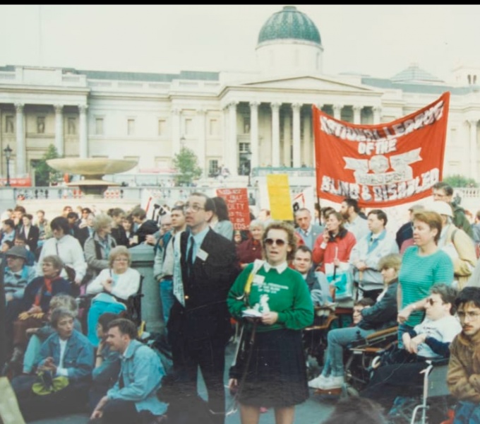 A photograph featuring hundreds of people demonstrating for Disability Rights in Trafalgar Square, London.